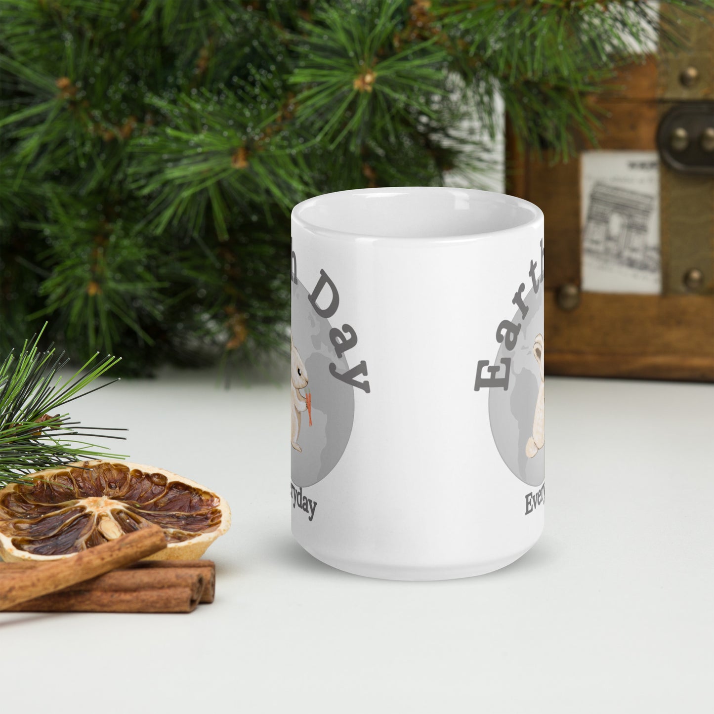 White Earth Day Everyday Rabbit Ceramic Mug with nature-themed design next to pine and dried orange slices