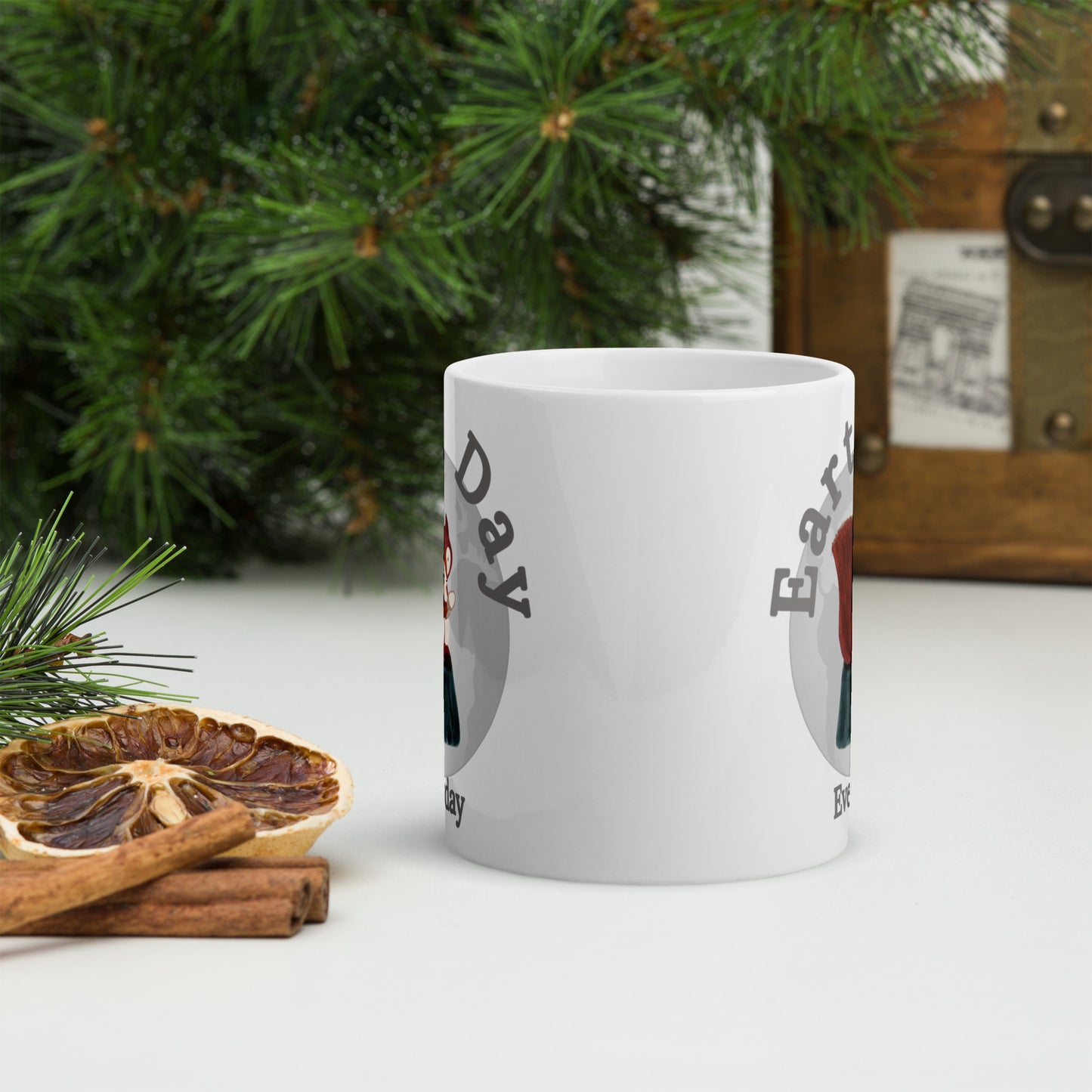 Earth Day Everyday Squirrels Ceramic Mug with nature-themed design placed next to dried orange and cinnamon sticks