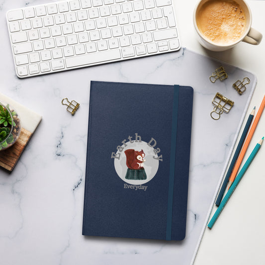 Earth Day Everyday Squirrels Hardcover Notebook with squirrel illustration on navy blue cover on desk with keyboard coffee and pencils