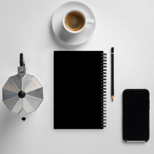 Earth Day Everyday Squirrels Spiral Notebook with black cover next to coffee, pencil, and smartphone on white desk